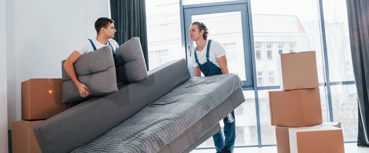 Removalists moving grey couch