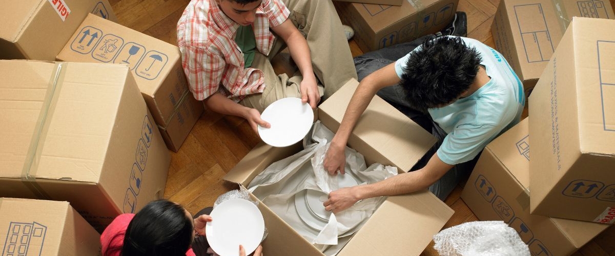 Friends packing dishes