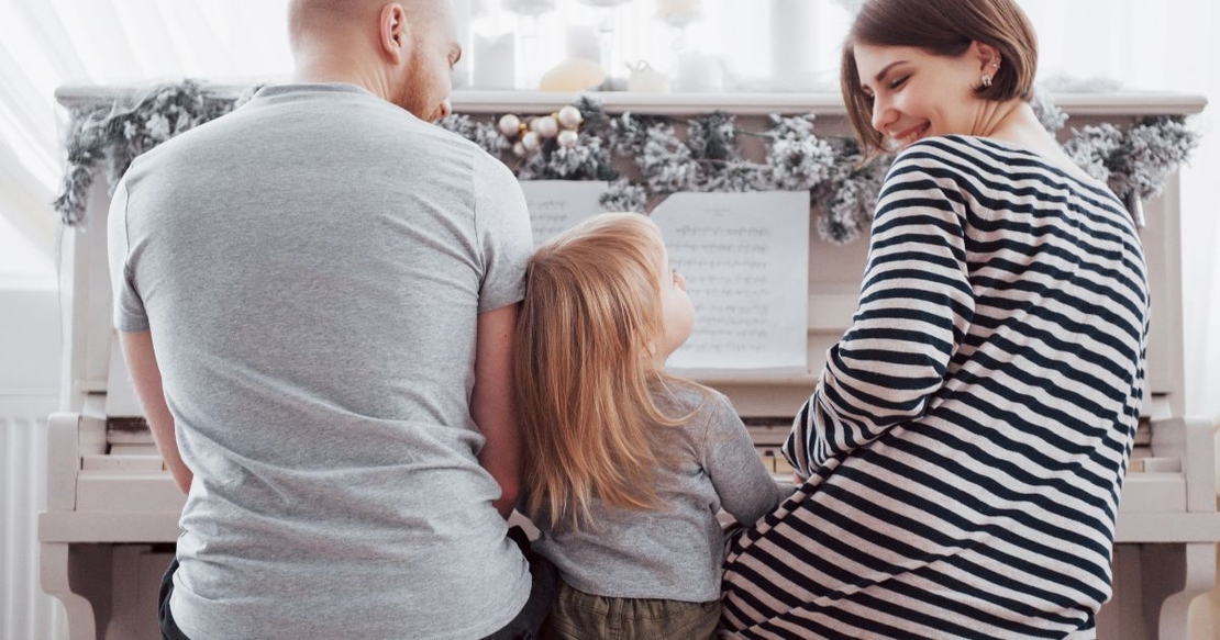 Family playing a piano together