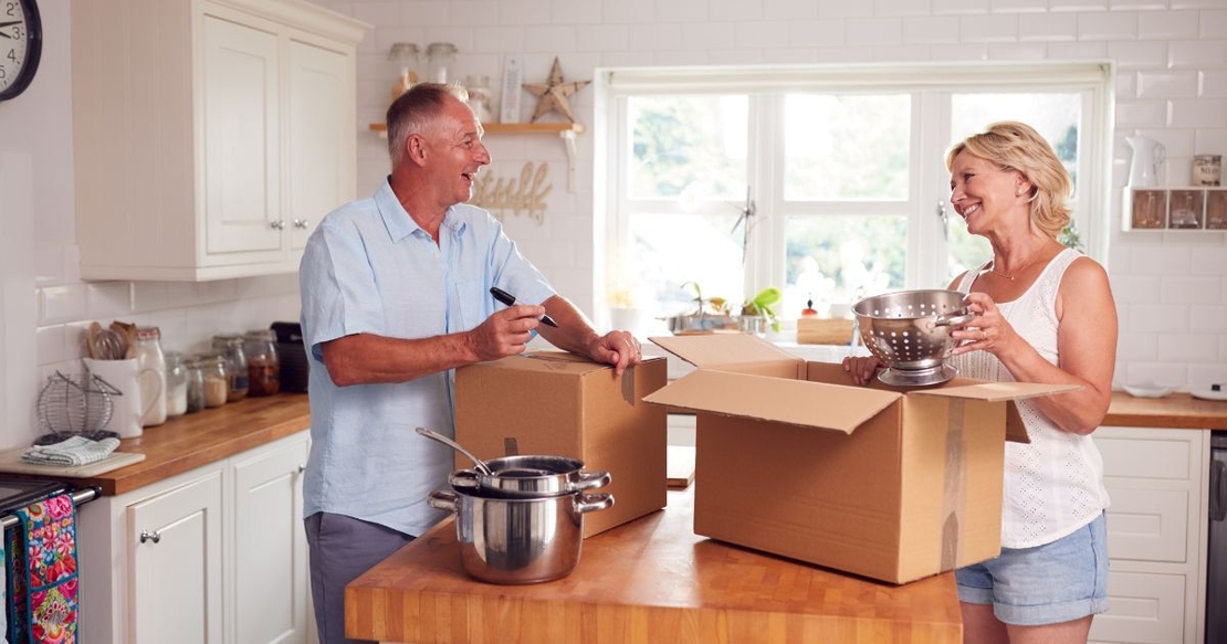 happy couple packing up kitchen