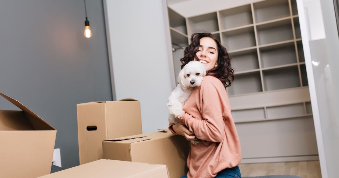 Woman with boxes and dog